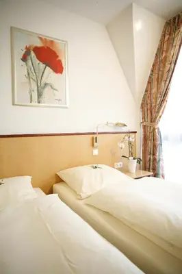 Ein Bett oder Betten in einem Zimmer der Unterkunft Hotel St. Pierre