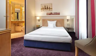 Ein Bett oder Betten in einem Zimmer der Unterkunft Parkhotel Weiskirchen