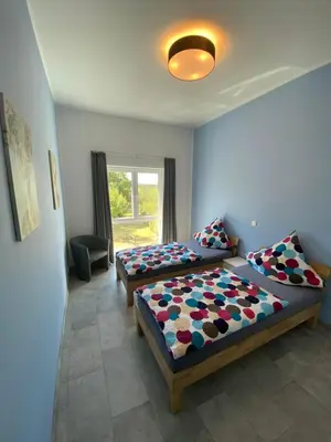 Ein Bett oder Betten in einem Zimmer der Unterkunft Ferienwohnungen Eifelausblick
