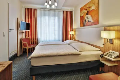 Ein Bett oder Betten in einem Zimmer der Unterkunft Hotel Trierer Hof