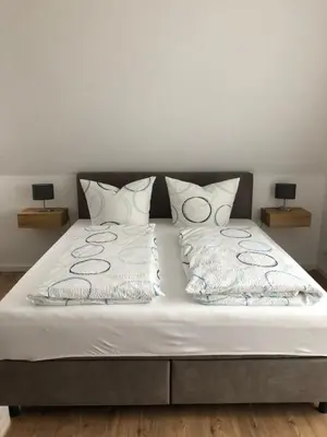 Ein Bett oder Betten in einem Zimmer der Unterkunft Wein und Gästehaus Hüls