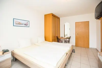 Ein Bett oder Betten in einem Zimmer der Unterkunft Hotel Pizzeria VENEZIA