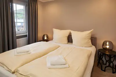 Ein Bett oder Betten in einem Zimmer der Unterkunft Winzerhaus Wehlener Sonnenuhr