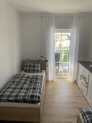 Ein Bett oder Betten in einem Zimmer der Unterkunft Im Blauen Ländchen