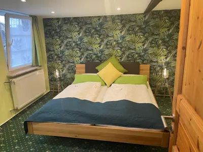 Ein Bett oder Betten in einem Zimmer der Unterkunft Hotel Garni Maaß