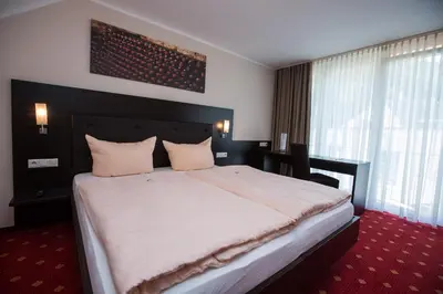 Ein Bett oder Betten in einem Zimmer der Unterkunft Parkhotel Cochem- Free Parking -