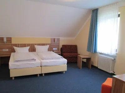 Ein Bett oder Betten in einem Zimmer der Unterkunft Landhotel Karrenberg