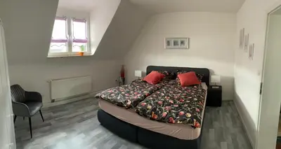 Ein Bett oder Betten in einem Zimmer der Unterkunft Erica Ferienwohnung auf dem Traumpfad