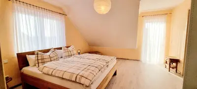Ein Bett oder Betten in einem Zimmer der Unterkunft Ferienhaus Antiquarius