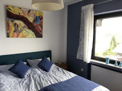 Ein Bett oder Betten in einem Zimmer der Unterkunft Ferienhaus Schöner Maarblick