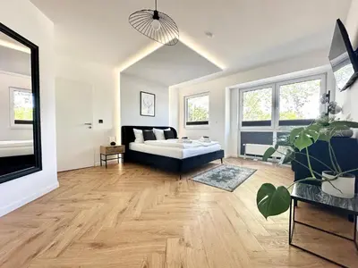 Ein Bett oder Betten in einem Zimmer der Unterkunft Modern Apartment - für Freunde & Familien, stadtnah, Parkplatz, E-Ladestation, Gitterbox für Fahrräder, Fitnessstudio, digitale Gästemappe mit Restaurant- und Unternehmenstipps