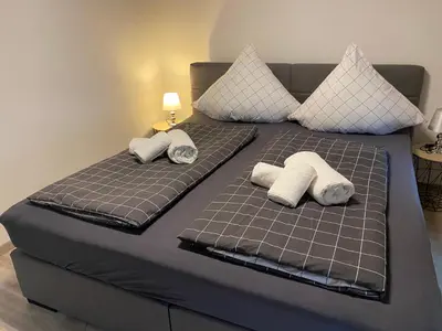 Ein Bett oder Betten in einem Zimmer der Unterkunft Sonnenlay Lounge - Studio & Ferienhaus