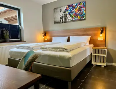 Ein Bett oder Betten in einem Zimmer der Unterkunft JUNIPRO Apartments & Rooms