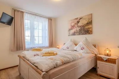 Ein Bett oder Betten in einem Zimmer der Unterkunft Ferienwohnungen Am Eifelsteig